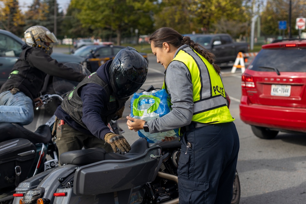 The 10th Mountain Division Sustainment Brigade help distribute water outside of the Watertown Municipal Arena to residents of Watertown, New York.