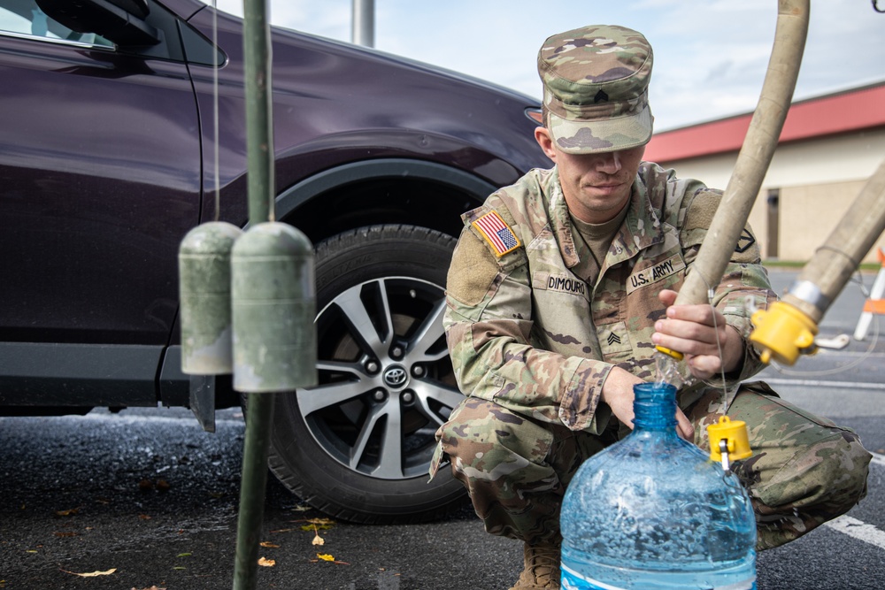 The 10th Mountain Division Sustainment Brigade 548th Combat Sustainment Support Battalion help distribute water outside of the Watertown Municipal Arena to residents of Watertown, New York.