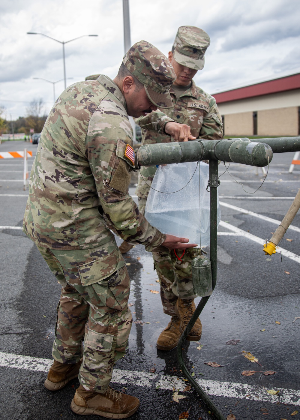 The 10th Mountain Division Sustainment Brigade 548th Combat Sustainment Support Battalion help distribute water outside of the Watertown Municipal Arena to residents of Watertown, New York.