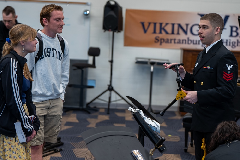 Musician 1st Class Justin Mendez works with students at Spartanburg Highschool