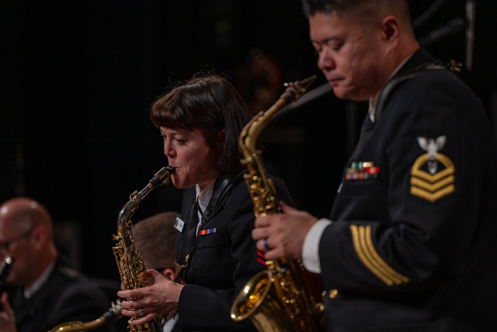 Musician 1st Class Amanda Ballantine and Chief Musician Andrew Francisco performs a dueling Sax solo