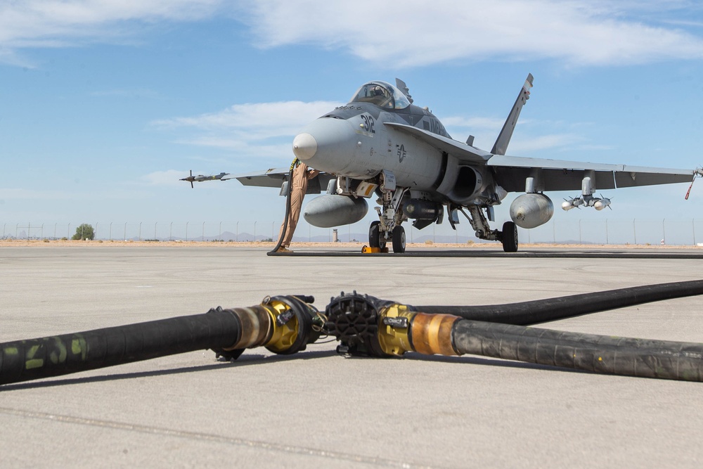 U.S. Marines perform an air delivery ground refueling on F/A-18 Hornet aircraft