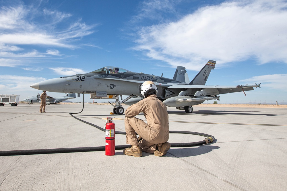 U.S. Marines perform an air delivery ground refueling on F/A-18 Hornet aircraft