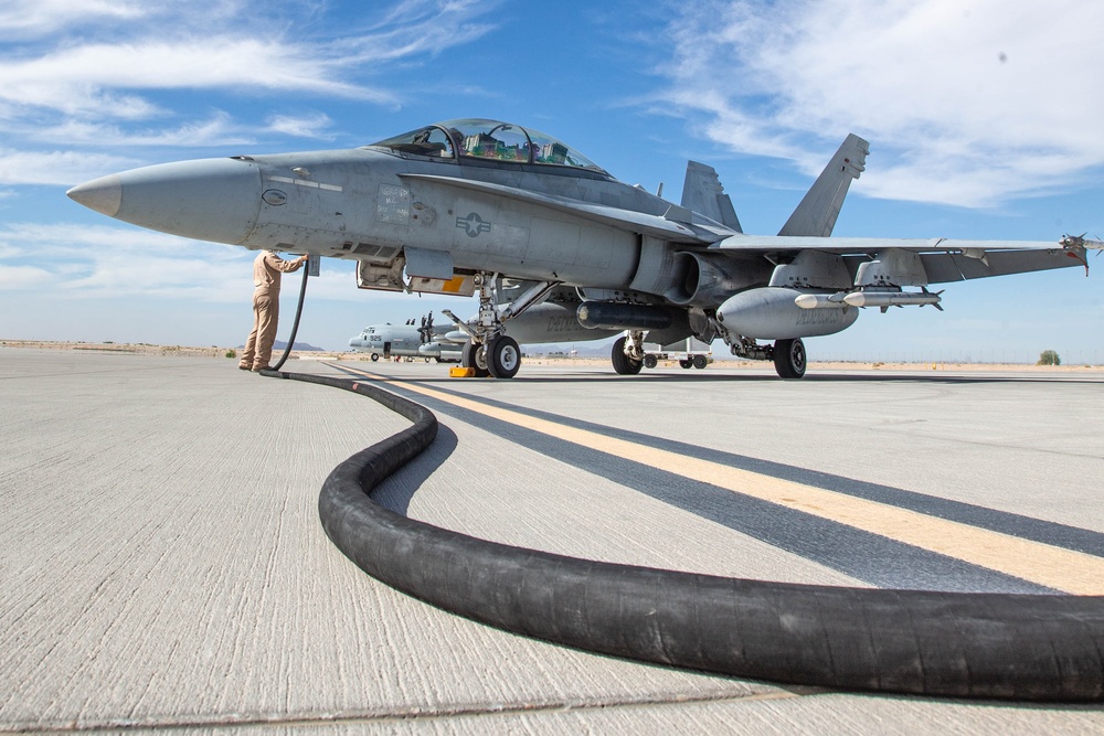 U.S. Marines perform an air delivery ground refueling on F/A-18 Hornet aircraft