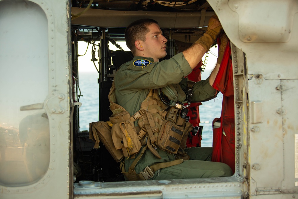 HSC-14 Sailor conducts pre-flight check