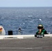 Abraham Lincoln Sailor stands watch on the flight deck