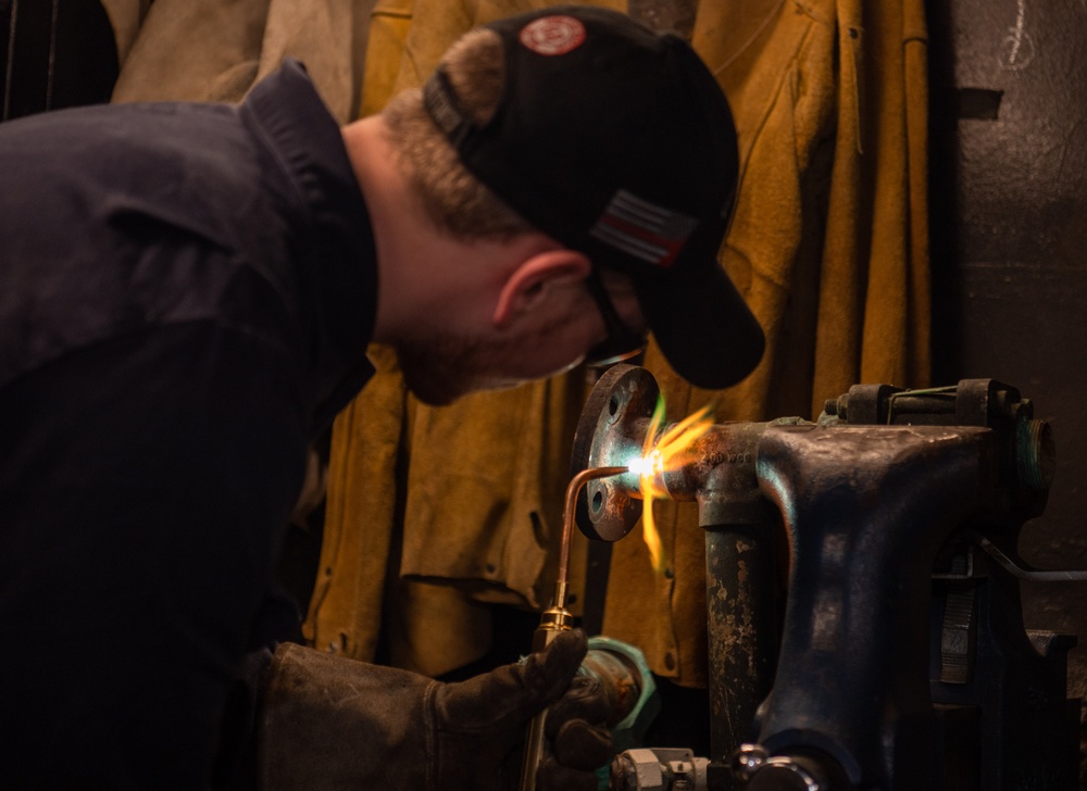 U.S. Navy Sailor Brazes Pipe