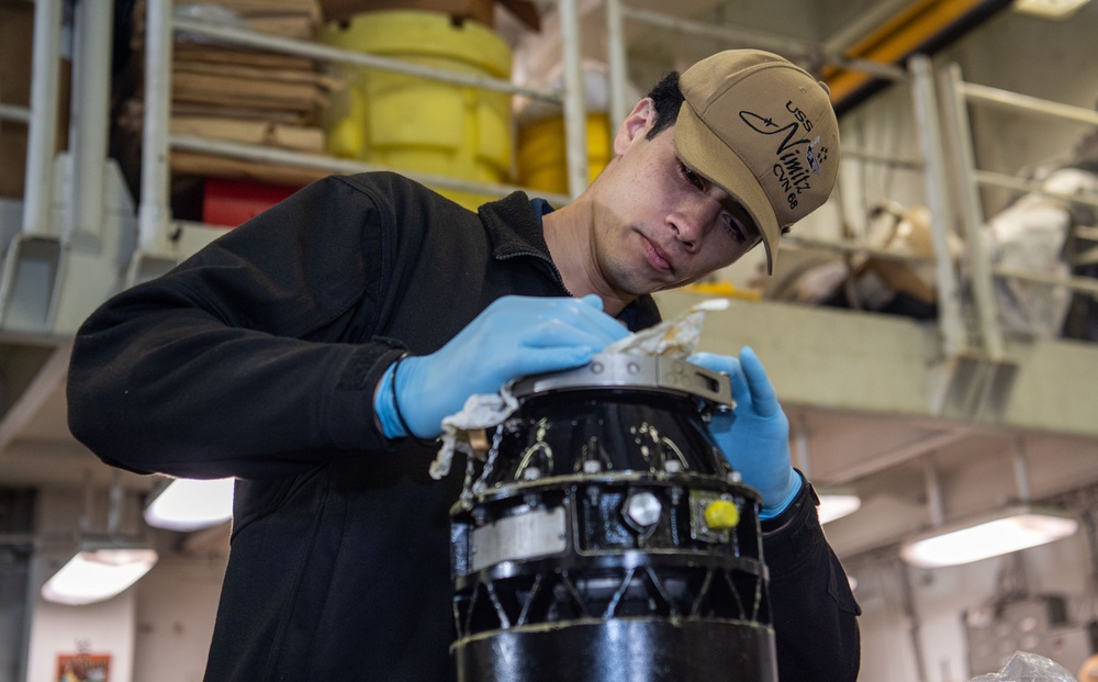 U.S. Navy  Sailor Inspects Engine Starter