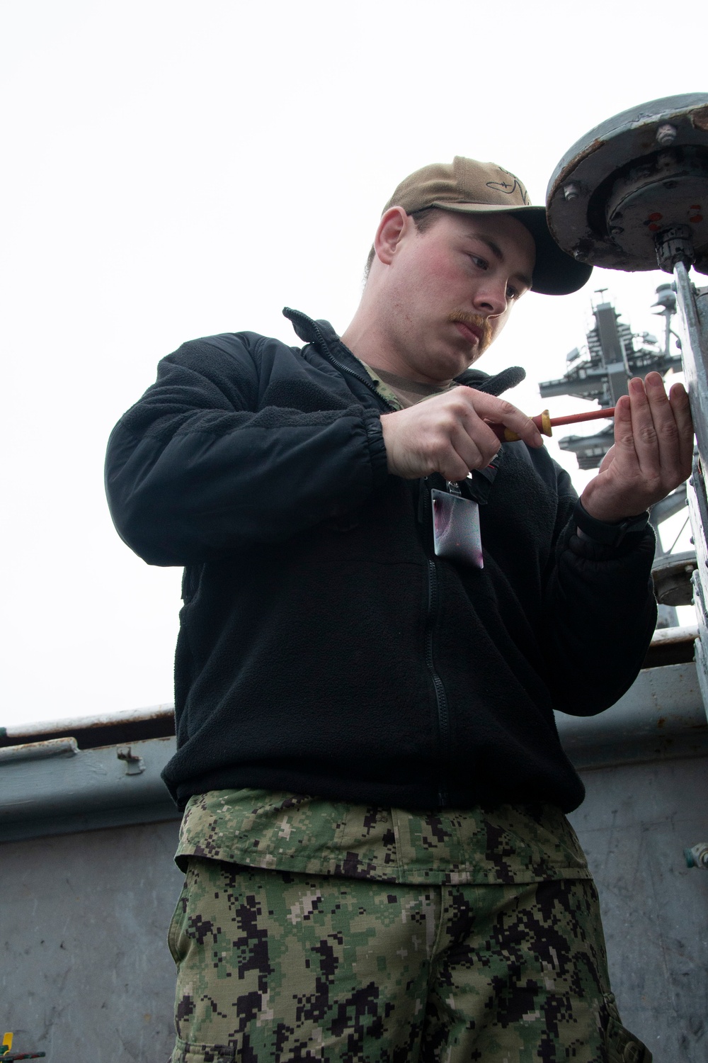 U.S. Navy Sailor Checks Deckhead Lights