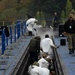 U.S. Navy Sailors Scrape Grease From Catapult Trough