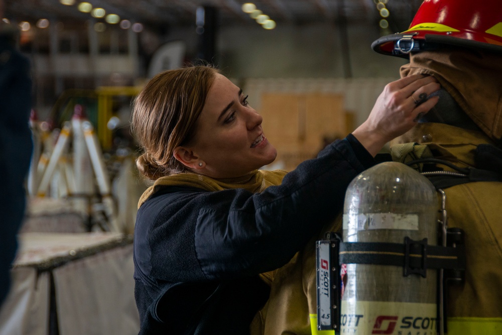 U.S. Navy Sailor Dons Firefighting Ensemble