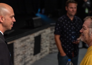 Chief Musician Jonathan Barnes speaks with a concert goer at Pace Assembly of God Church
