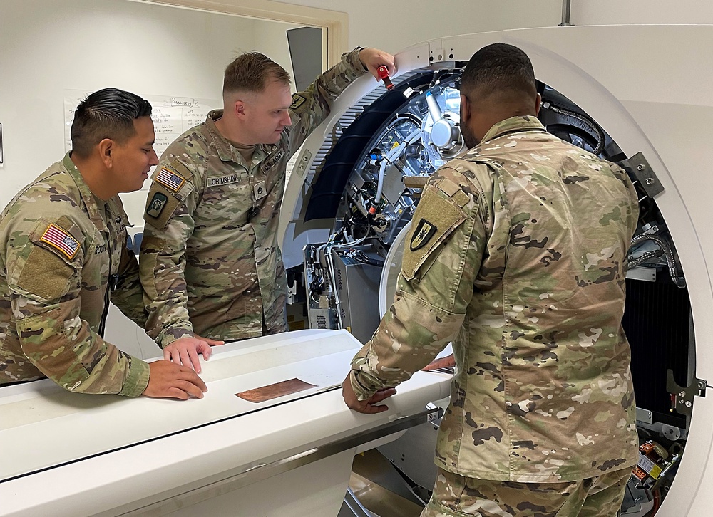 Soldiers inspect CT machine