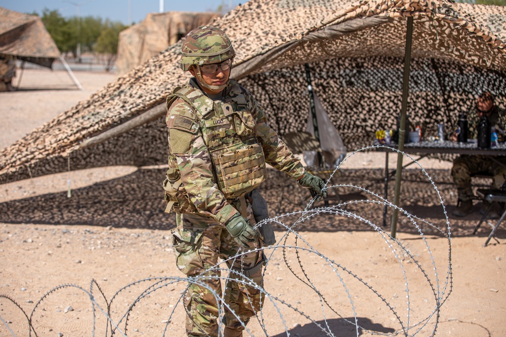 Spc. Antonio Lugo moves concertina wire