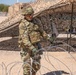 Spc. Antonio Lugo moves concertina wire