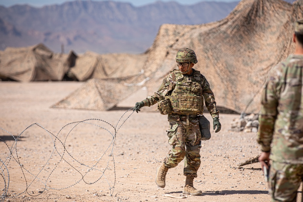 U.S. Army Soldier Moves Concertina Wire