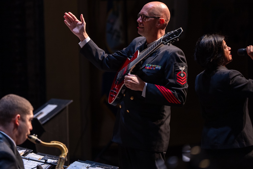 Chief Musician Shawn Purcell conducts the band at Saenger Theater