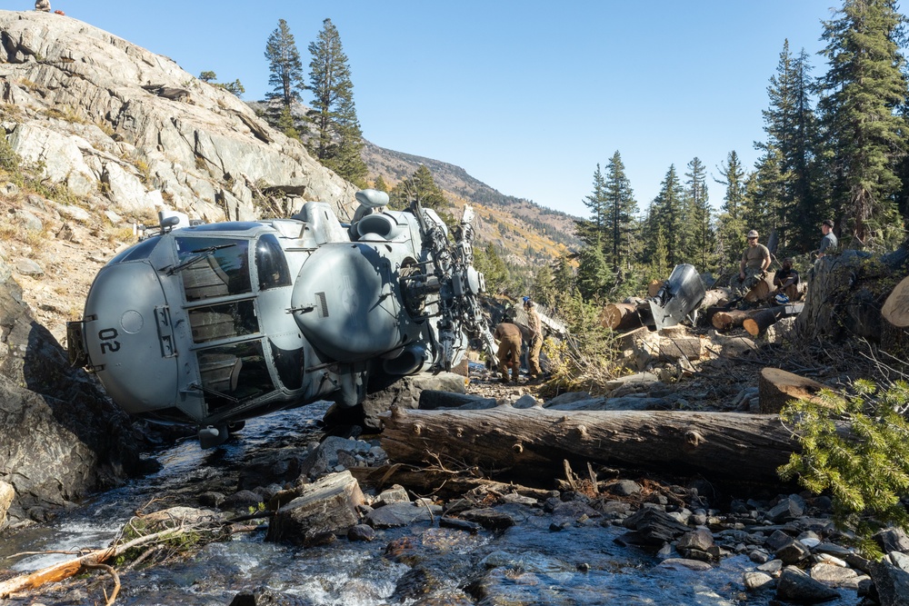 U.S. Marines, Sailors, and Forest Service personnel work to recover a downed U.S. Navy MH-60S Seahawk