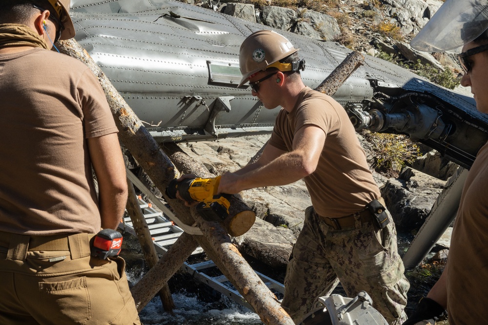 U.S. Marines, Sailors, and Forest Service personnel work to recover a downed U.S. Navy MH-60S Seahawk