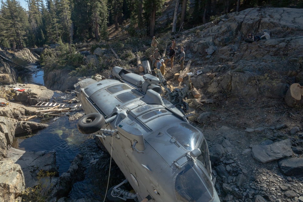 U.S. Marines, Sailors, and Forest Service personnel work to recover a downed U.S. Navy MH-60S Seahawk