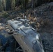 U.S. Marines, Sailors, and Forest Service personnel work to recover a downed U.S. Navy MH-60S Seahawk