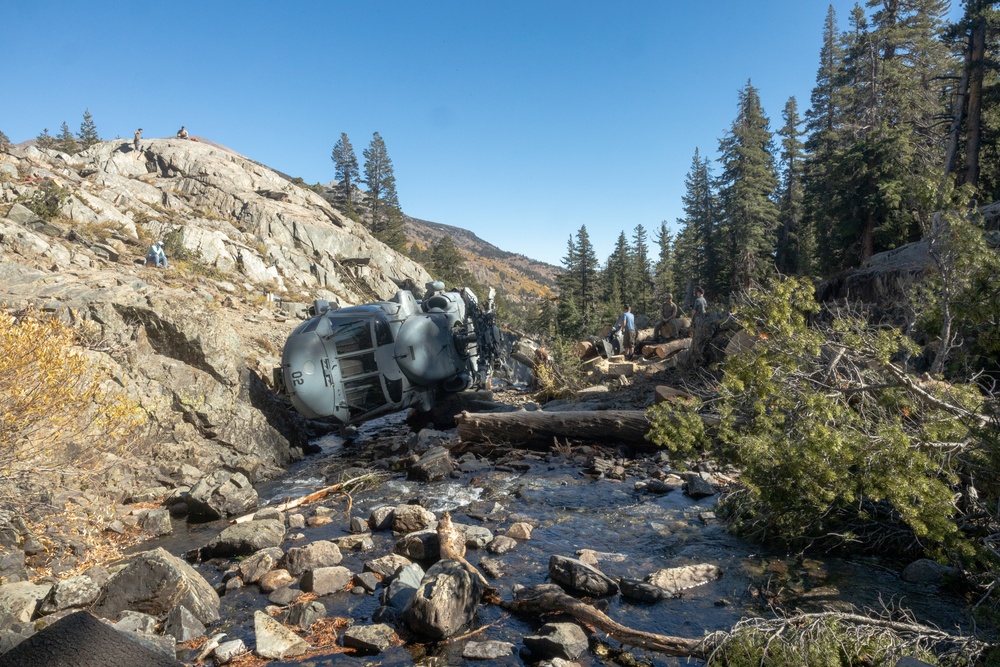 U.S. Marines, Sailors, and Forest Service personnel work to recover a downed U.S. Navy MH-60S Seahawk