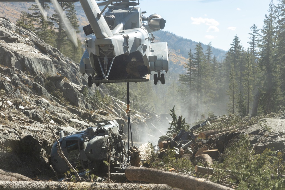 U.S. Marines, Sailors, and Forest Service personnel recover a downed U.S. Navy MH-60S Seahawk