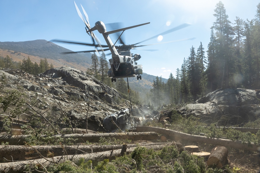 U.S. Marines, Sailors, and Forest Service personnel recover a downed U.S. Navy MH-60S Seahawk