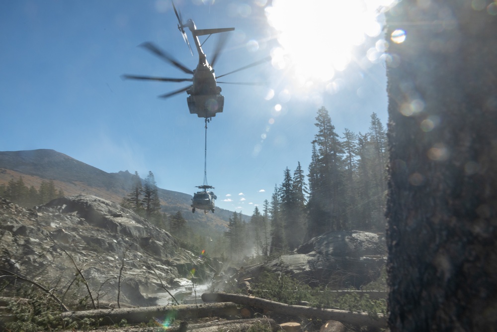 U.S. Marines, Sailors, and Forest Service personnel recover a downed U.S. Navy MH-60S Seahawk