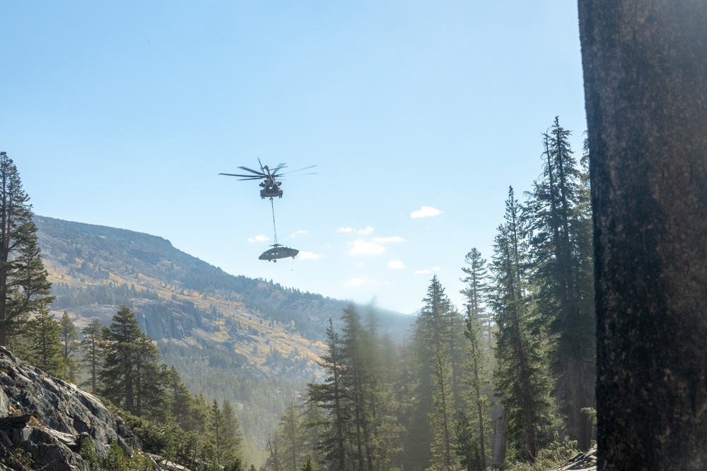 U.S. Marines, Sailors, and Forest Service personnel recover a downed U.S. Navy MH-60S Seahawk