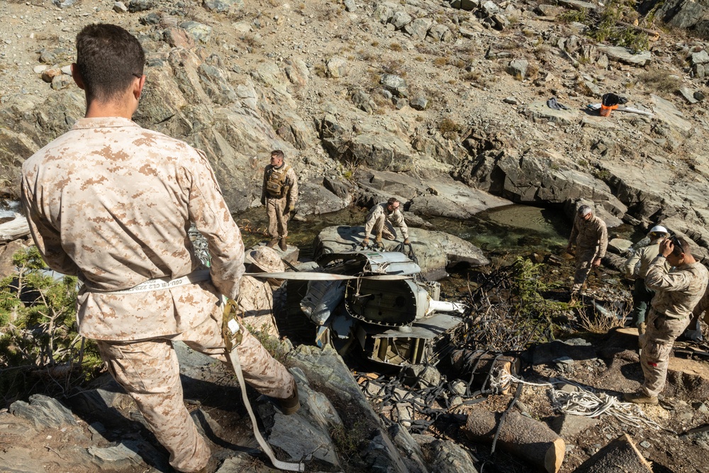 U.S. Marines, Sailors, and Forest Service personnel recover a downed U.S. Navy MH-60S Seahawk