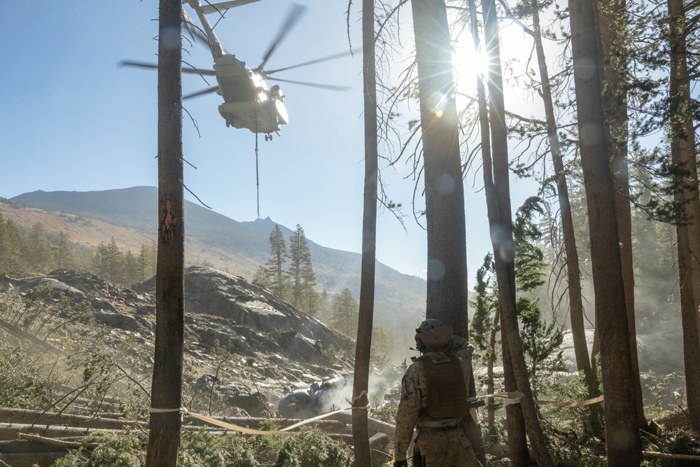 U.S. Marines, Sailors, and Forest Service personnel recover a downed U.S. Navy MH-60S Seahawk