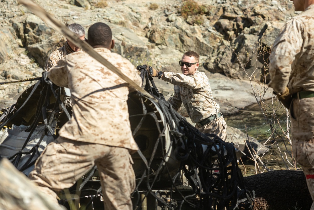 U.S. Marines, Sailors, and Forest Service personnel recover a downed U.S. Navy MH-60S Seahawk