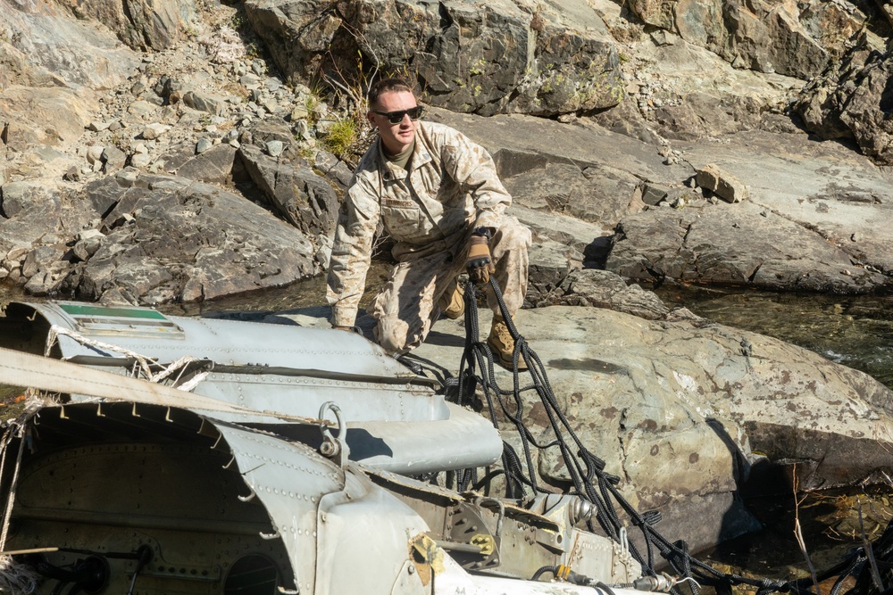 U.S. Marines, Sailors, and Forest Service personnel recover a downed U.S. Navy MH-60S Seahawk