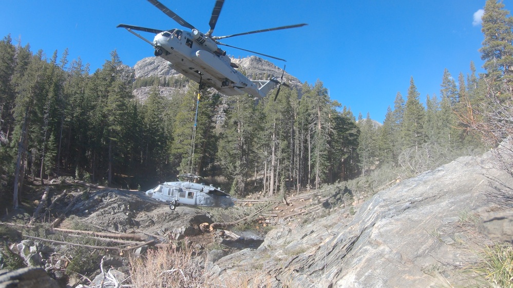 U.S. Marines, Sailors, and Forest Service personnel recover a downed U.S. Navy MH-60S Seahawk