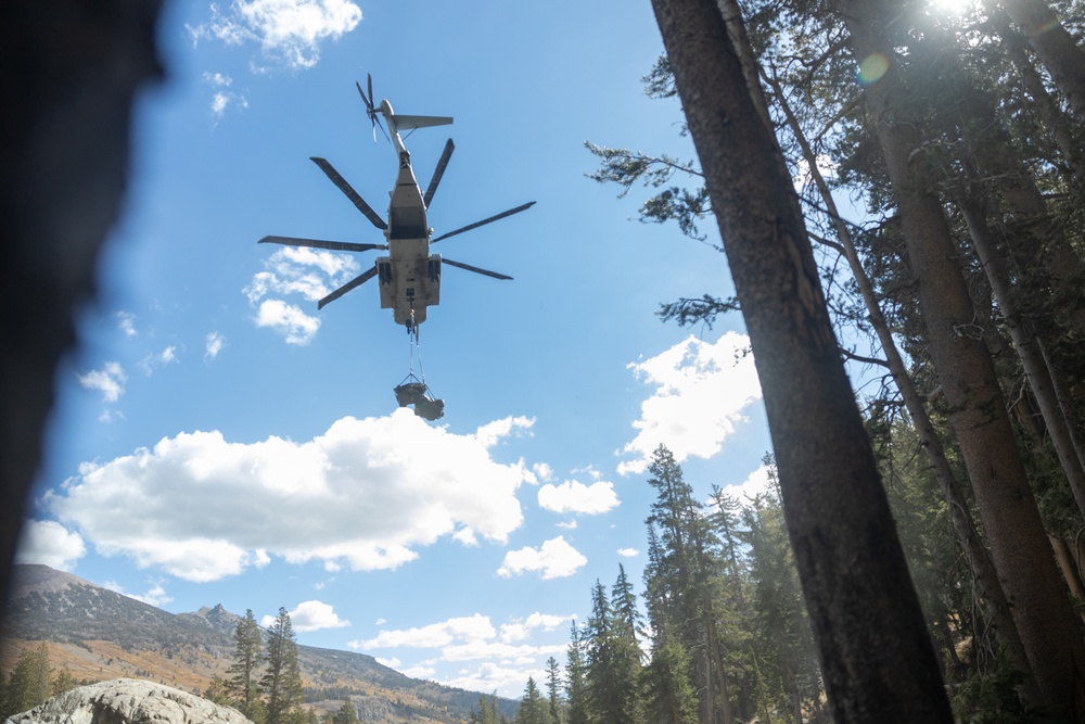 U.S. Marines, Sailors, and Forest Service personnel recover a downed U.S. Navy MH-60S Seahawk