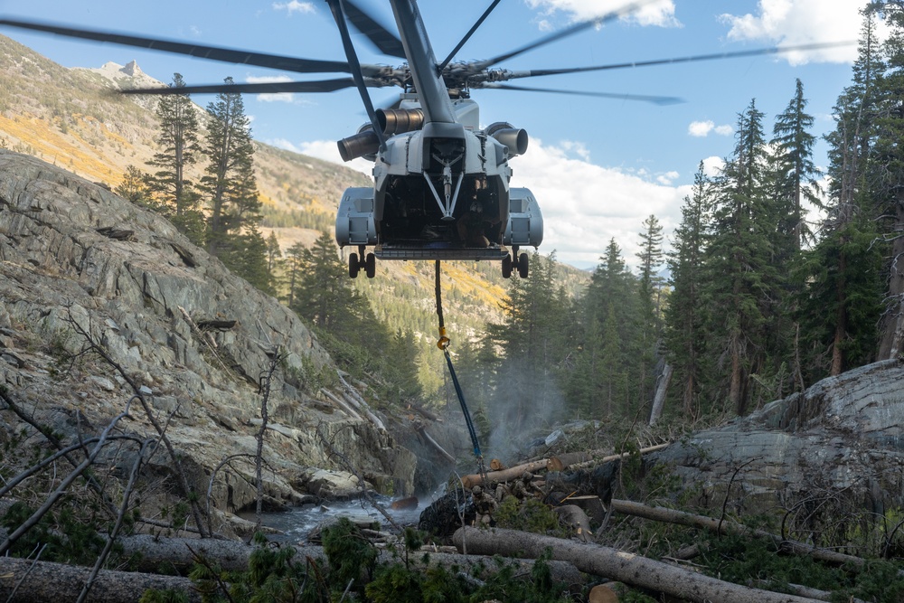 U.S. Marines, Sailors, and Forest Service personnel recover a downed U.S. Navy MH-60S Seahawk