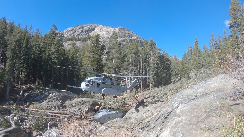 U.S. Marines, Sailors, and Forest Service personnel recover a downed U.S. Navy MH-60S Seahawk