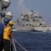 Sailors aboard the USS Rafael Peralta (DDG 115) conduct a replenishment-at-sea with the Lewis and Clark-class dry cargo USNS Wally Schirra (T-AKE-8) in the South China Sea