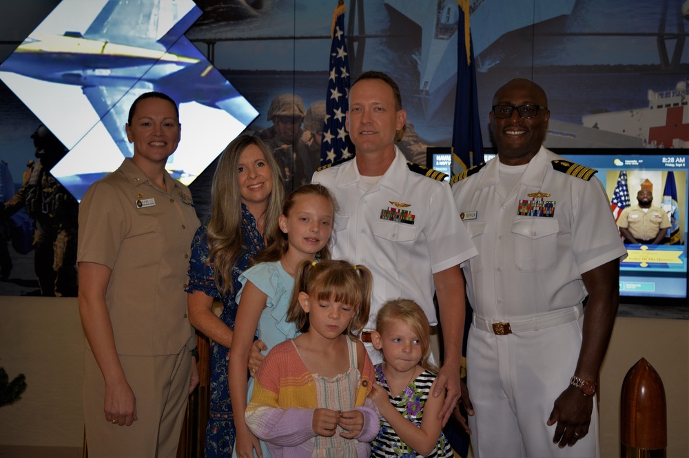 CDR Martin with his family and the Command Officer of NHC Charleston