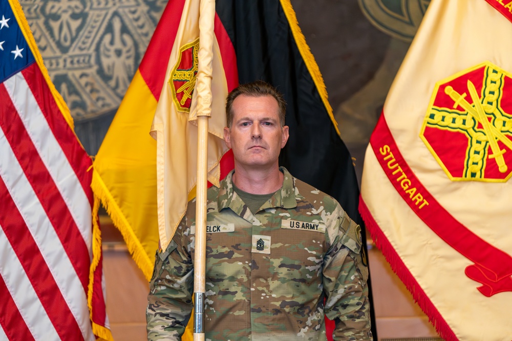 U.S. Army 1st Sgt.  Richard Telck stands at attention with Unit Colors