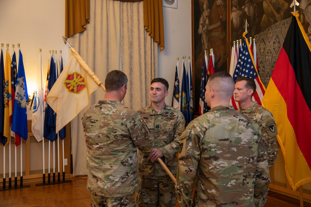 U.S. Army Capt. Andrew Horn passes the unit colors to Garrison Commander Col. Kirck Alexander