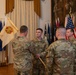 U.S. Army Capt. Andrew Horn passes the unit colors to Garrison Commander Col. Kirck Alexander