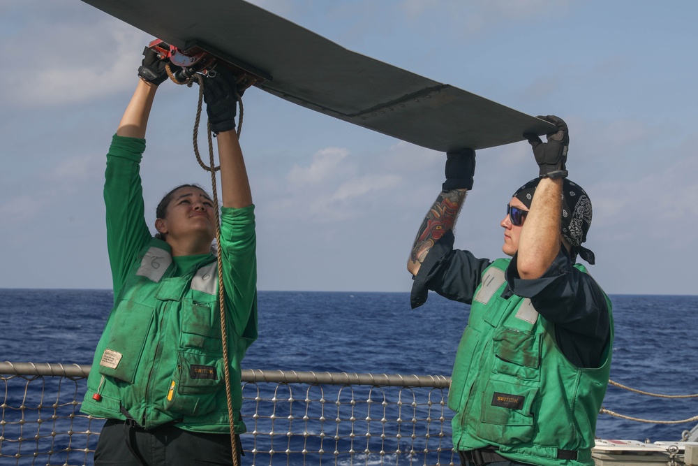 Sailors aboard the USS Rafael Peralta (DDG 115) conduct a crash and salvage drill in the South China Sea