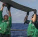 Sailors aboard the USS Rafael Peralta (DDG 115) conduct a crash and salvage drill in the South China Sea