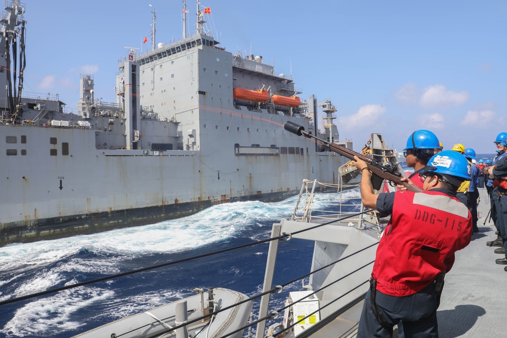 Sailors aboard the USS Rafael Peralta (DDG 115) conduct a replenishment-at-sea with the Lewis and Clark-class dry cargo USNS Wally Schirra (T-AKE-8) in the South China Sea