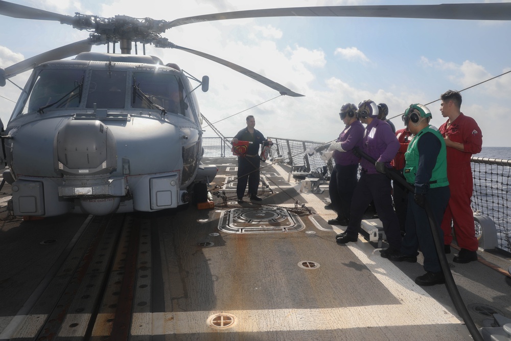 Sailors aboard the USS Rafael Peralta (DDG 115) conduct a crash and salvage drill in the South China Sea