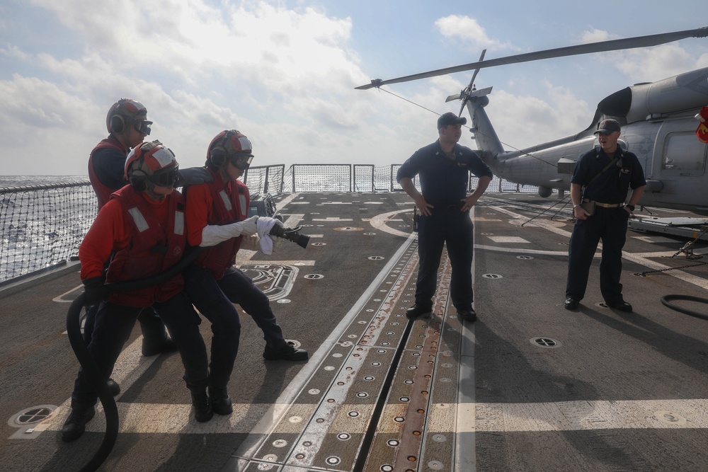 Sailors aboard the USS Rafael Peralta (DDG 115) conduct a crash and salvage drill in the South China Sea