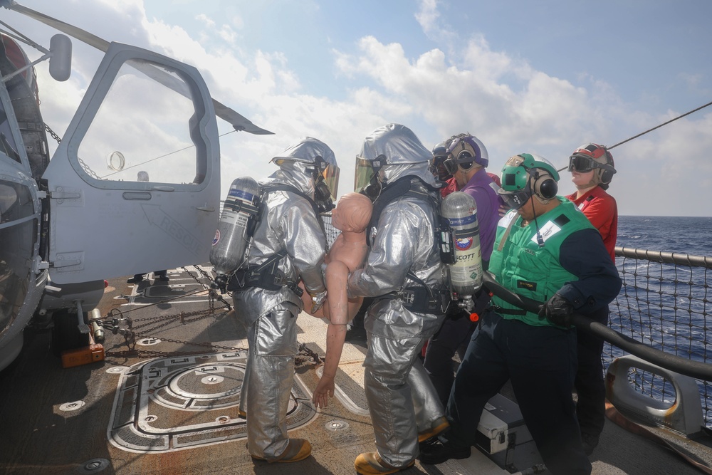 Sailors aboard the USS Rafael Peralta (DDG 115) conduct a crash and salvage drill in the South China Sea