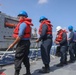 Sailors aboard the USS Rafael Peralta (DDG 115) conduct a replenishment-at-sea with the Lewis and Clark-class dry cargo USNS Wally Schirra (T-AKE-8) in the South China Sea